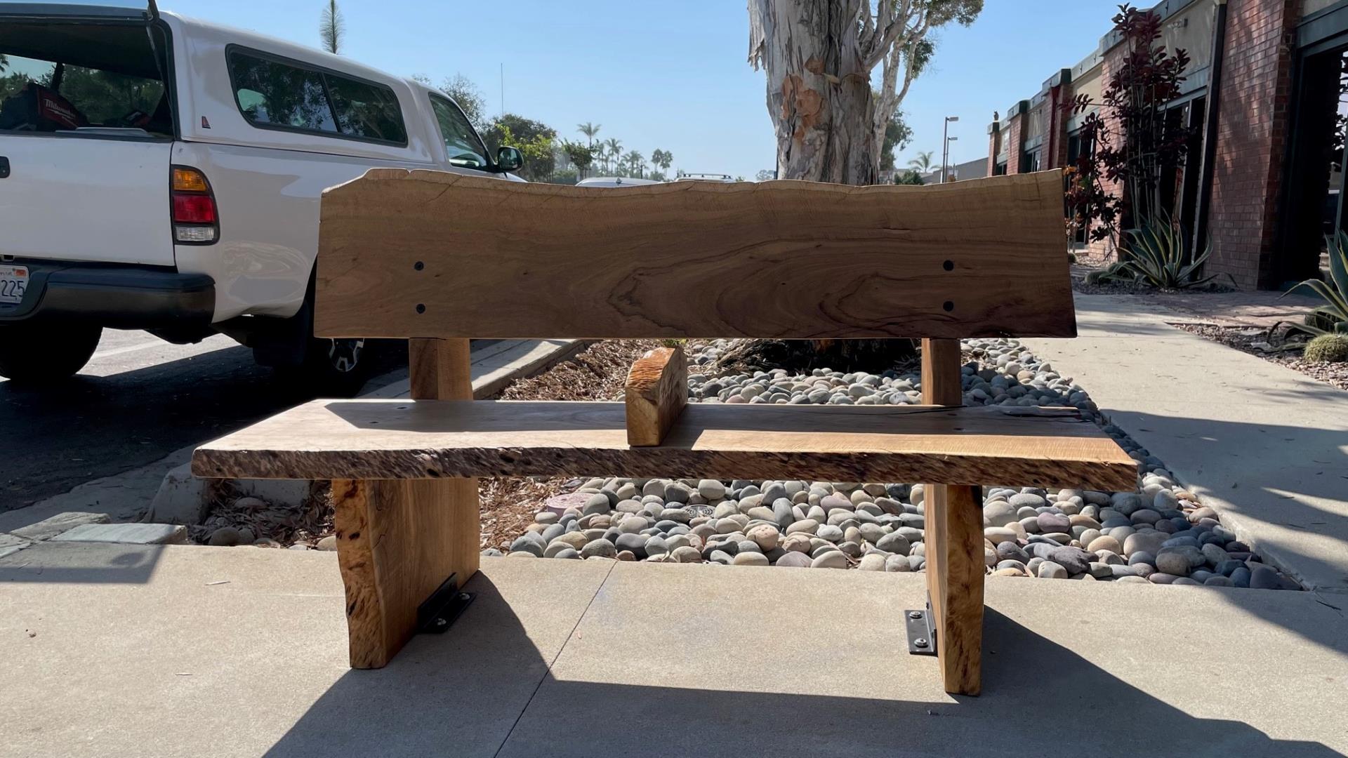 wooden bench on sidewalk