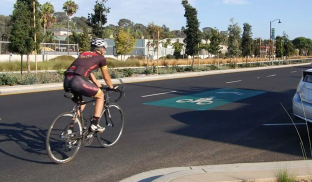 image of rider on highway 101 next to bike sharrow